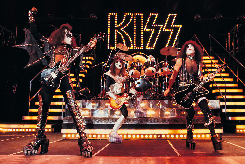 Kiss live concert poster showing the iconic band performing on stage with dynamic lighting and vibrant colours